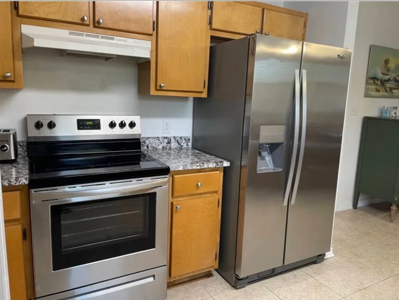 Deep cleaned kitchen with gleaming appliances by Pretty City Cleaners